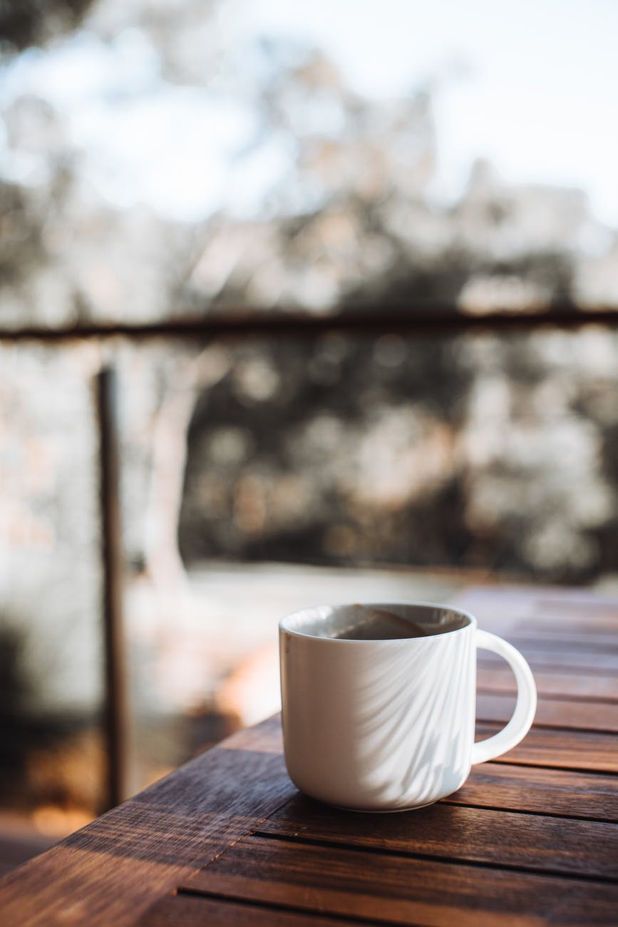 mug of coffee on wooden table