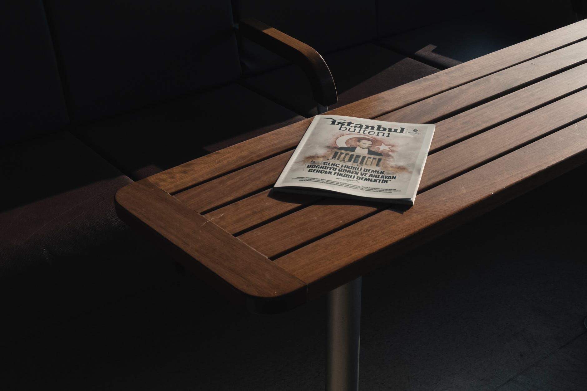 turkish magazine placed on wooden table near chairs